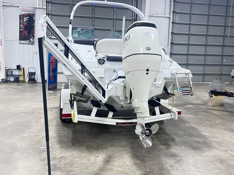 Slide: The Image of 2020 Crownline Eclipse E225 XS boat with Suzuki 250 outboard motor in a garage. - 6