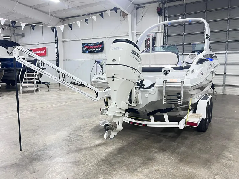 Slide: The Image of 2020 Crownline Eclipse E225 XS boat in showroom, featuring Suzuki outboard motor. - 7
