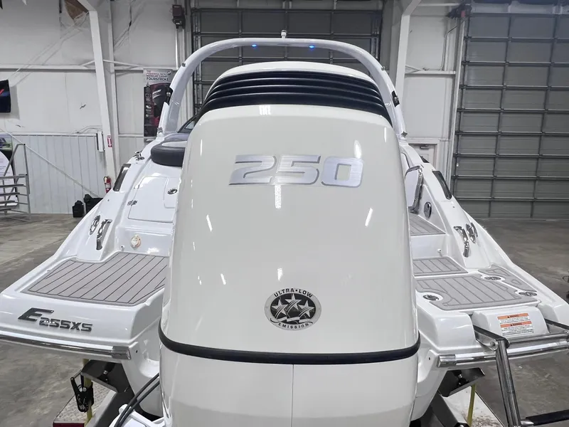 Slide: The Image of 2020 Crownline Eclipse E225 XS boat in a showroom, rear view. - 9