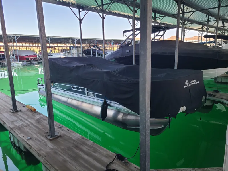 Slide: The Image of 2021 Sun Tracker 22 Fishin Barge covered at marina dock. - 4