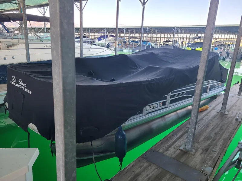 Slide: The Image of Covered 2021 Sun Tracker 22 Fishin Barge docked in a marina. - 6
