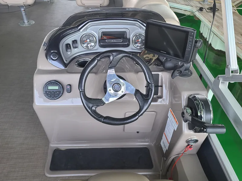 Slide: The Image of Steering console of 2021 Sun Tracker 22 Fishin Barge with navigation system and controls. - 9