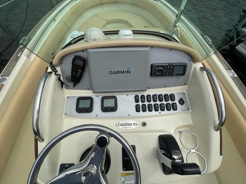 Slide: The Image of 2015 Chris-Craft Catalina 23 helm with Garmin navigation, controls, and steering wheel. - 13