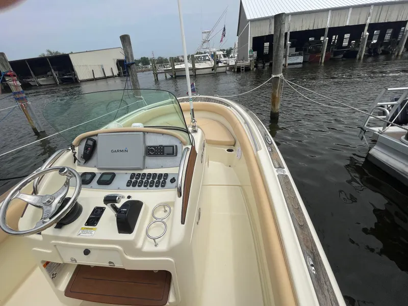Slide: The Image of 2015 Chris-Craft Catalina 23 boat interior with Garmin navigation system at a marina. - 16