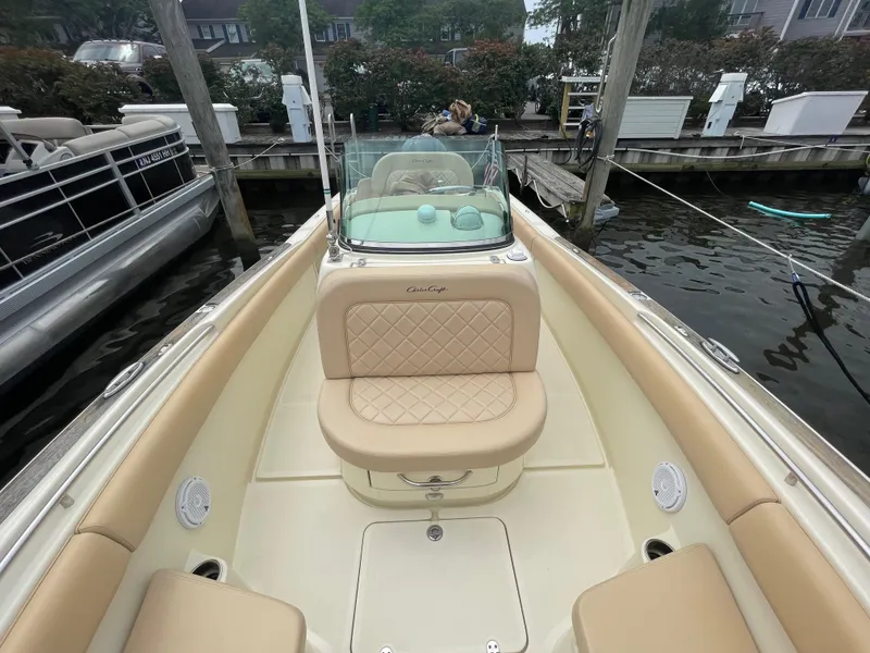 Slide: The Image of 2015 Chris-Craft Catalina 23 boat interior with beige seating at a dock. - 18