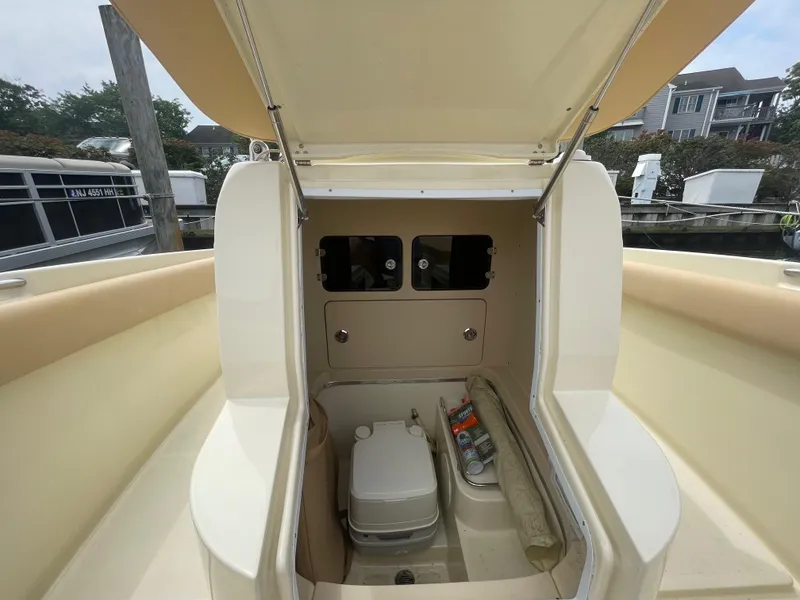 Slide: The Image of 2015 Chris-Craft Catalina 23 boat interior with storage compartment and portable toilet. - 19