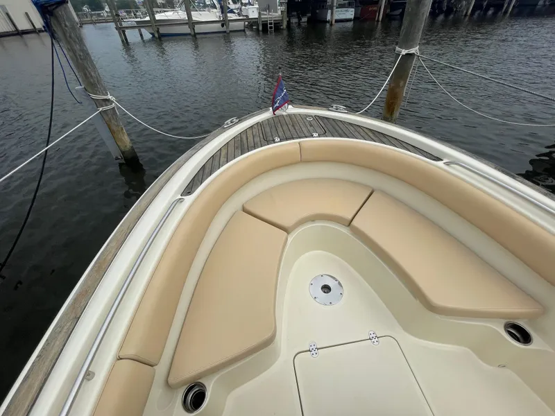 Slide: The Image of 2015 Chris-Craft Catalina 23 boat with beige seating, docked at a marina. - 23