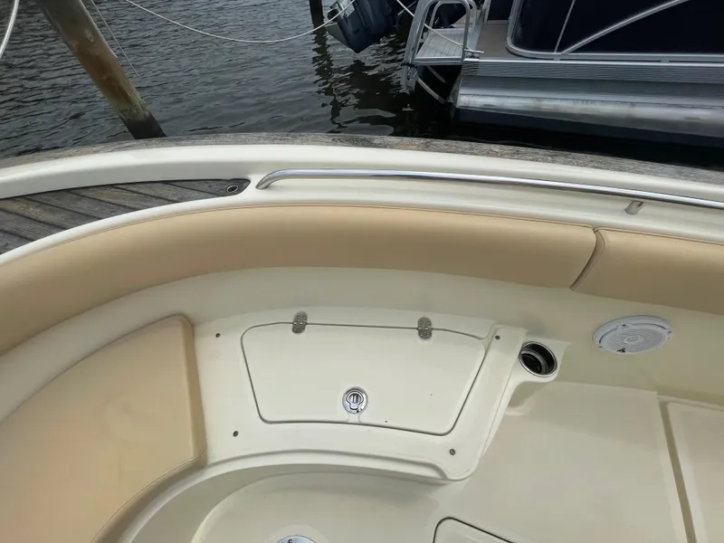 Slide: The Image of 2015 Chris-Craft Catalina 23 boat interior with beige seating and storage compartment. - 26