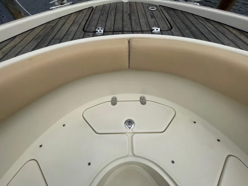 Slide: The Image of 2015 Chris-Craft Catalina 23 boat interior with cushioned seating and wooden deck. - 27