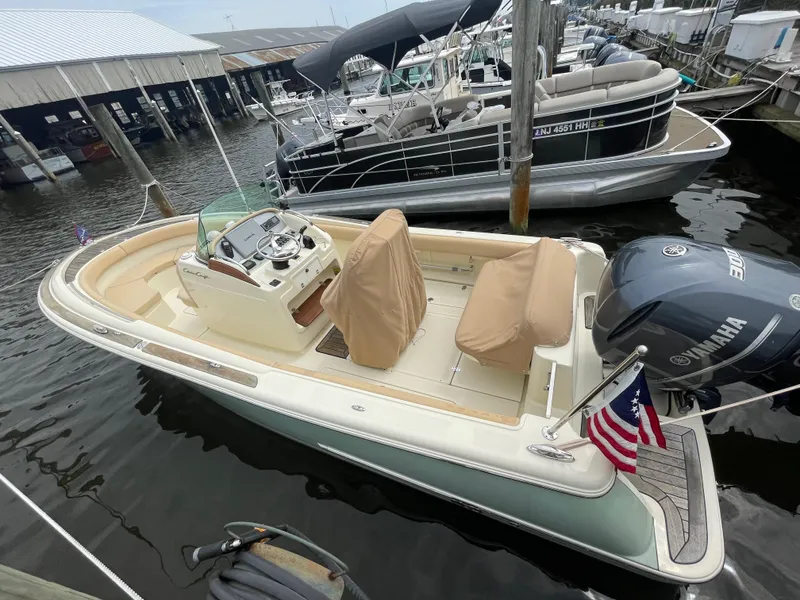 Slide: The Image of 2015 Chris-Craft Catalina 23 boat docked, featuring Yamaha engine and American flag. - 3