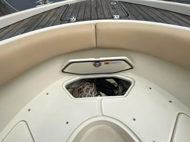 Slide: The Image of 2015 Chris-Craft Catalina 23 boat interior with storage compartment and ropes. - 30