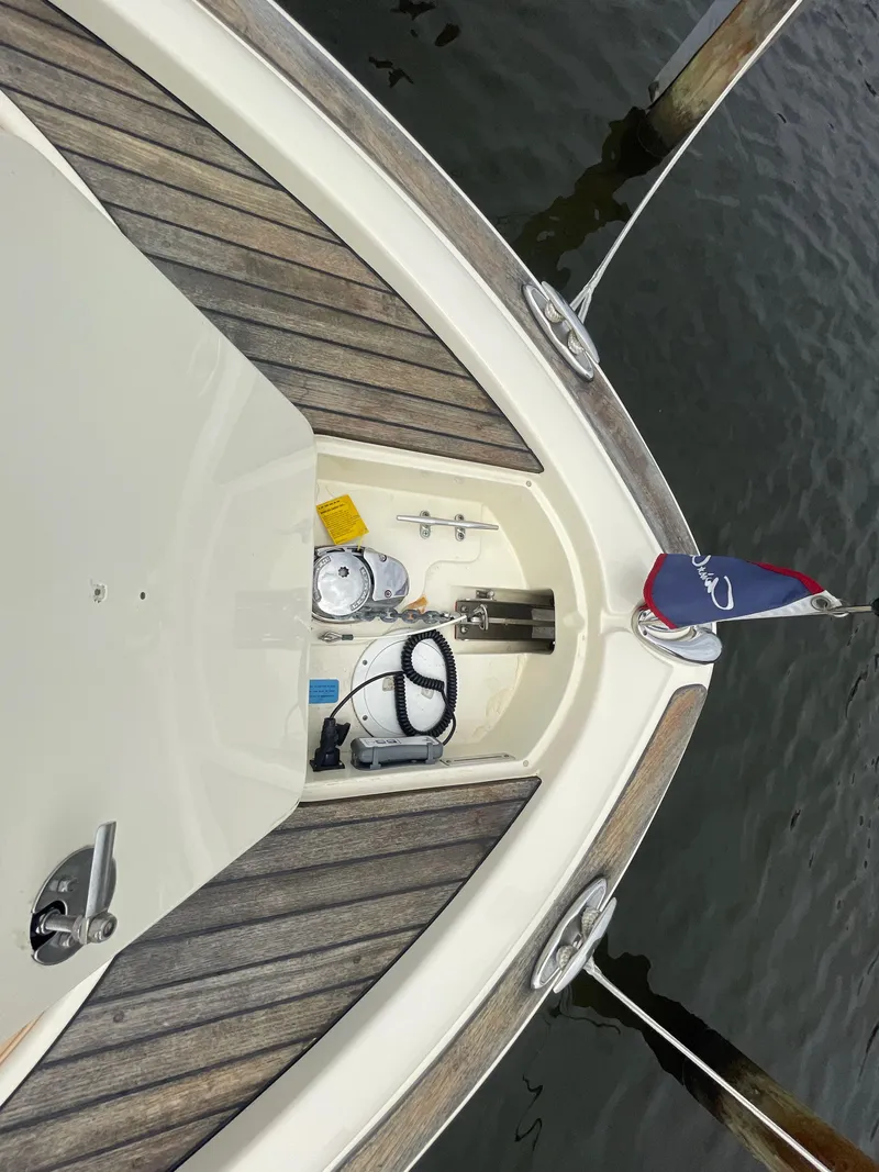 Slide: The Image of 2015 Chris-Craft Catalina 23 boat deck with anchor storage and flag. - 34