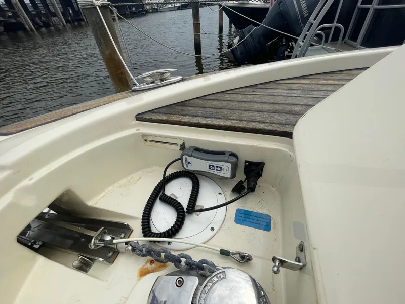 Slide: The Image of 2015 Chris-Craft Catalina 23 boat anchor compartment with control panel and coiled cable. - 35