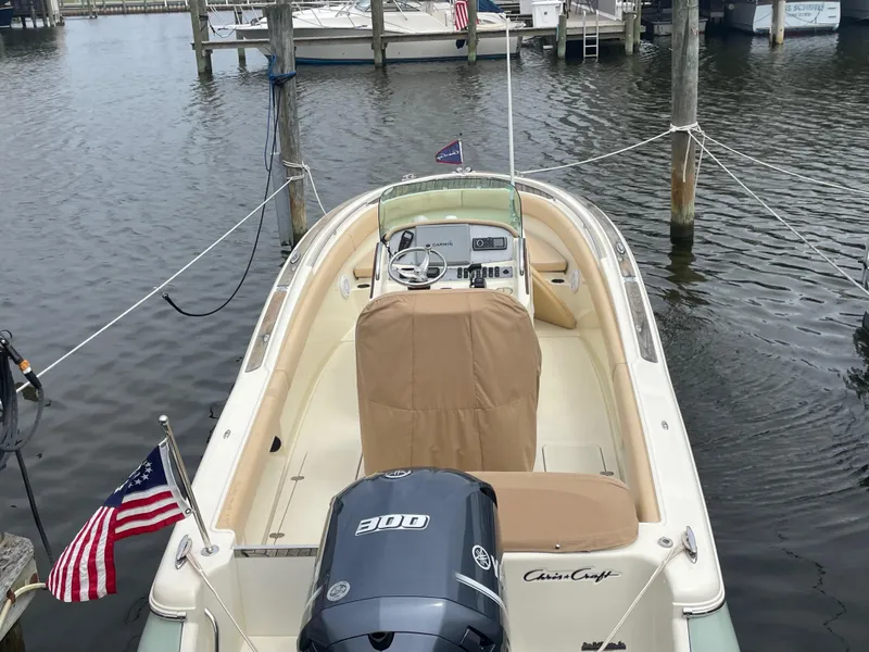 Slide: The Image of 2015 Chris-Craft Catalina 23 boat docked, featuring a Yamaha 300 engine and American flag. - 4
