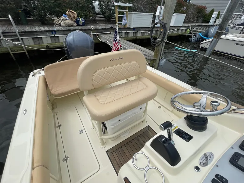 Slide: The Image of 2015 Chris-Craft Catalina 23 boat interior with steering wheel and seating. - 7