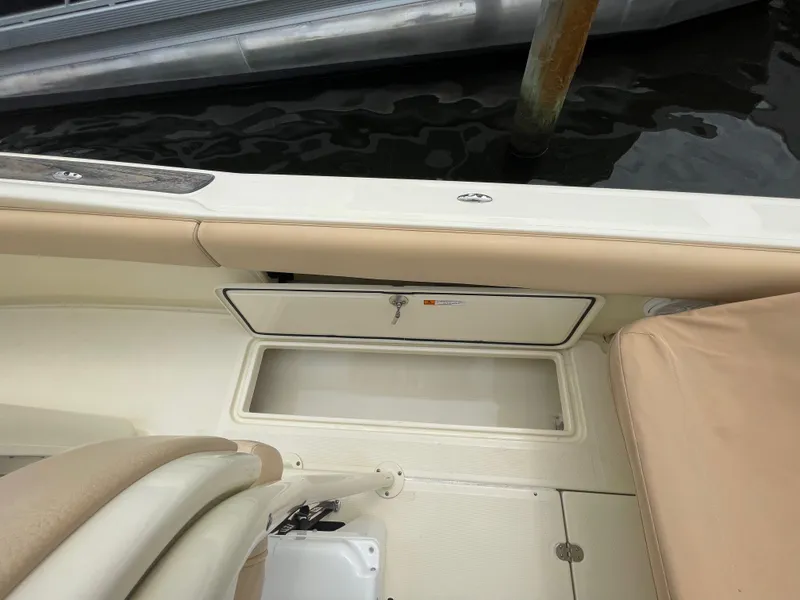 Slide: The Image of 2015 Chris-Craft Catalina 23 boat interior with storage compartment and seating. - 8
