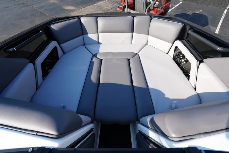 Slide: The Image of 2025 Moomba Max boat interior with gray and white cushioned seating. - 4