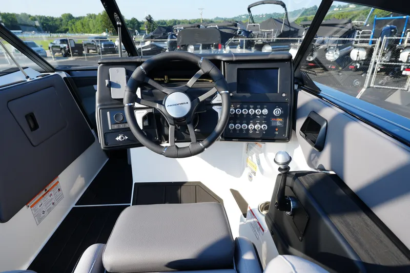 Slide: The Image of 2025 Moomba Max boat cockpit with steering wheel and control panel. - 9