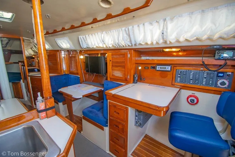 Slide: The Image of Interior of a 1987 Catalina 36 sailboat with wood finish and blue seating. - 10