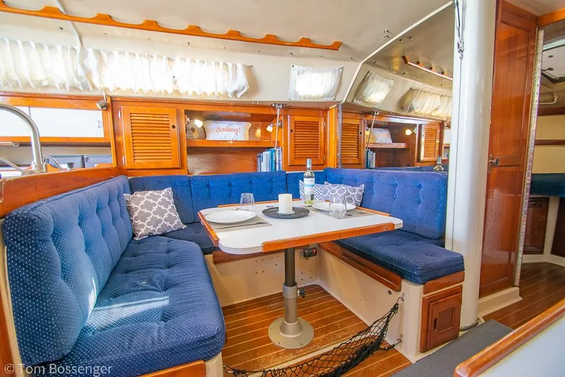 Slide: The Image of Interior of 1987 Catalina 36 sailboat with cozy dining area and blue upholstery. - 16