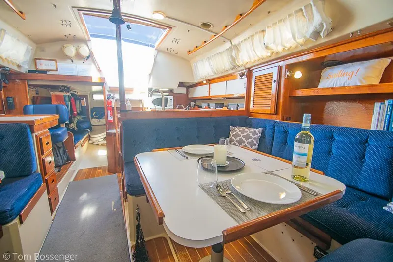 Slide: The Image of Interior of 1987 Catalina 36 sailboat with dining area and cozy seating. - 20