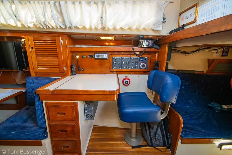 Slide: The Image of Interior of a 1987 Catalina 36 sailboat with navigation station and seating area. - 24