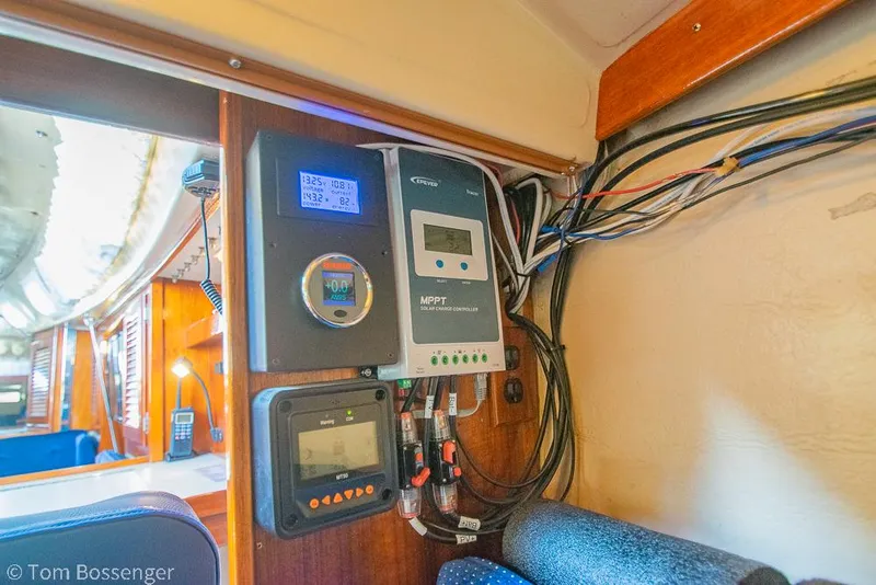 Slide: The Image of Electrical panel inside 1987 Catalina 36 sailboat, featuring MPPT solar charge controller. - 26