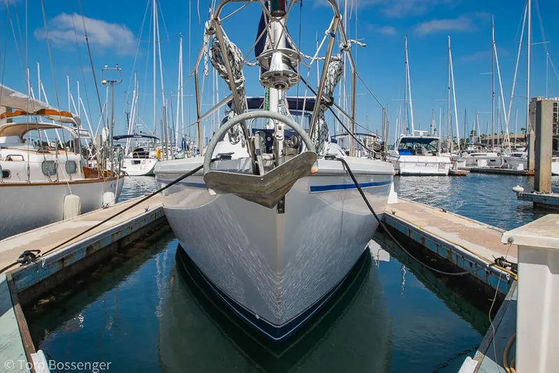 Slide: The Image of 1987 Catalina 36 sailboat docked in a marina, surrounded by other boats. - 3