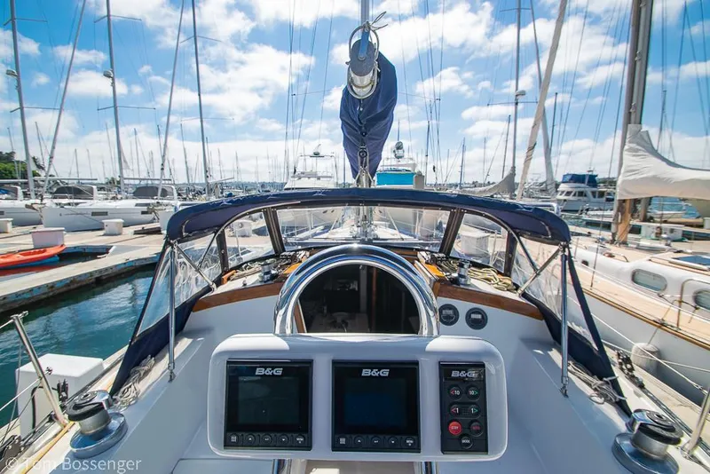 Slide: The Image of Cockpit view of 1987 Catalina 36 sailboat docked in a marina under blue skies. - 33