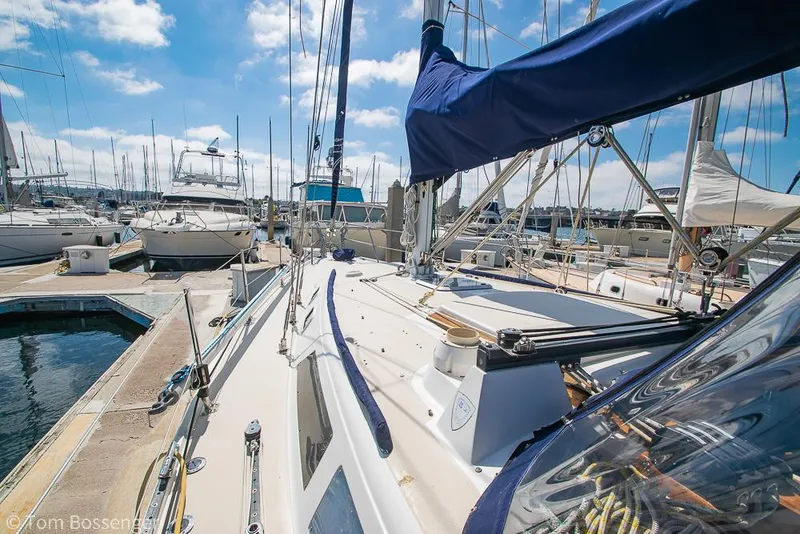 Slide: The Image of 1987 Catalina 36 sailboat docked at marina under blue sky. - 42