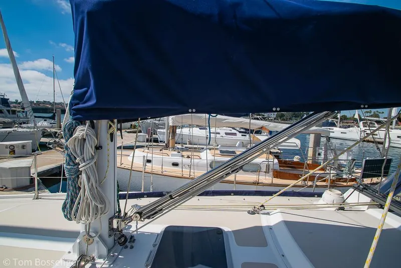 Slide: The Image of Catalina 36 sailboat from 1987 docked at a marina, featuring rigging and blue sail cover. - 43