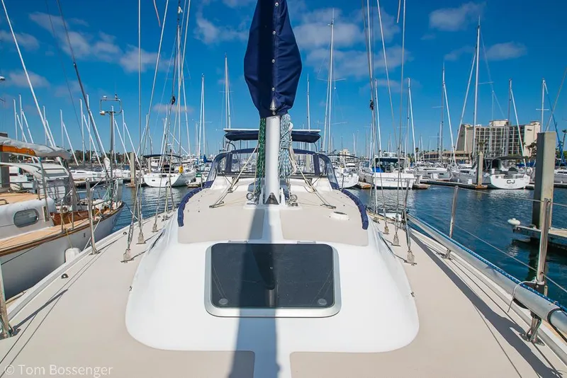 Slide: The Image of 1987 Catalina 36 sailboat docked in a marina under a clear blue sky. - 46