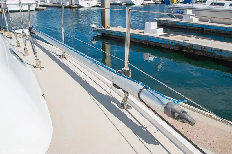 Slide: The Image of Catalina 36 sailboat deck, 1987 model, docked at marina with clear water. - 48