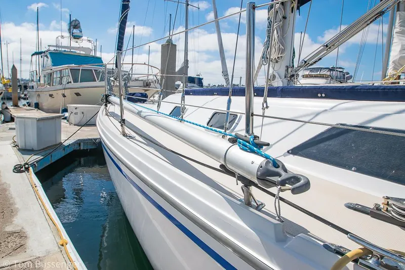 Slide: The Image of 1987 Catalina 36 sailboat docked at marina under clear blue sky. - 49