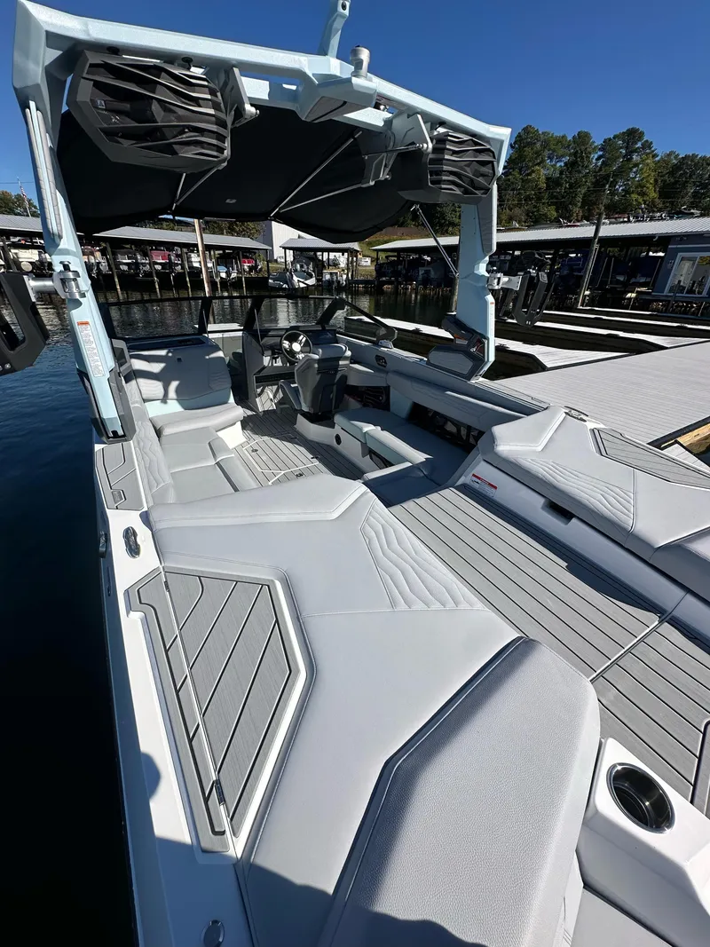 Slide: The Image of 2025 Nautique Super Air Nautique G23 boat interior with sleek seating and modern design. - 12