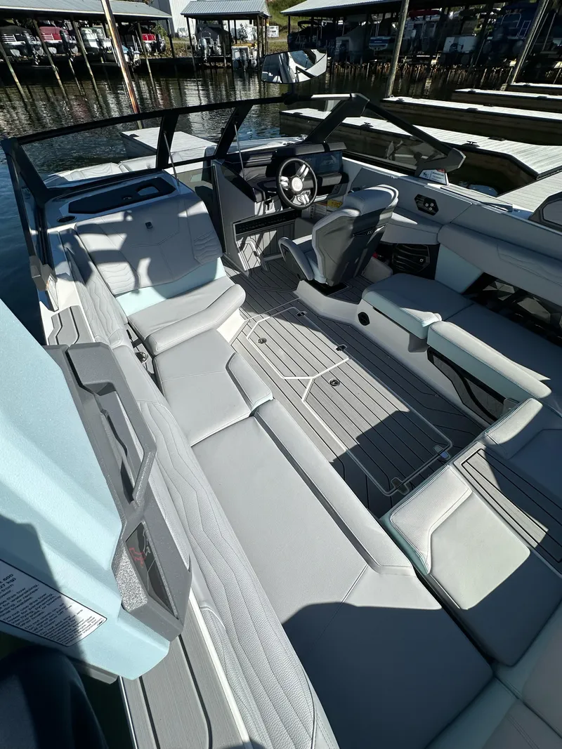 Slide: The Image of 2025 Nautique Super Air Nautique G23 interior with sleek seating and modern dashboard design. - 13