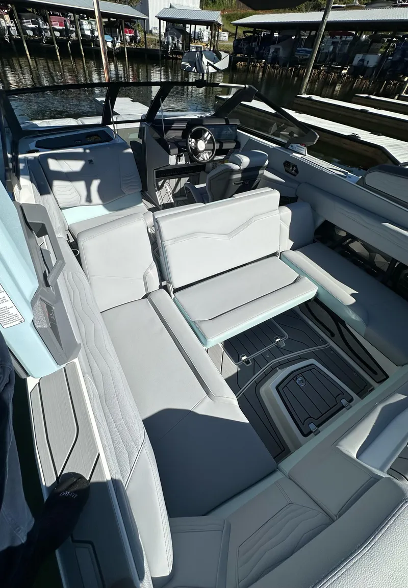 Slide: The Image of 2025 Nautique Super Air Nautique G23 interior with sleek seating and modern dashboard. - 14