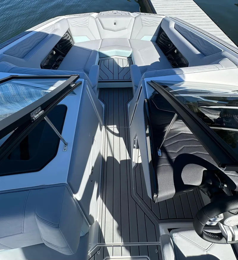Slide: The Image of 2025 Nautique Super Air Nautique G23 boat interior with sleek seating and modern design. - 17