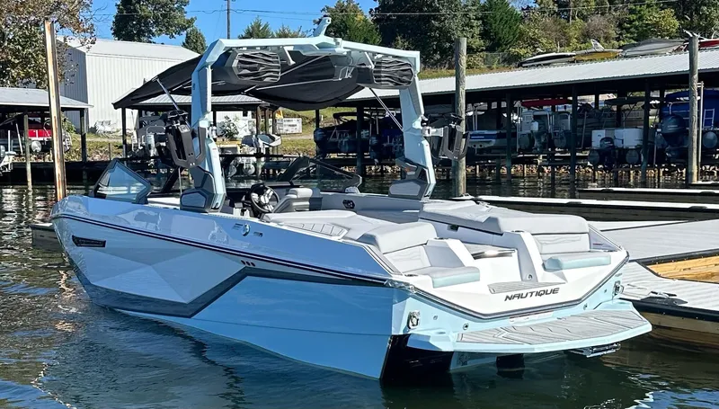 Slide: The Image of 2025 Nautique Super Air Nautique G23 boat docked at marina. - 3