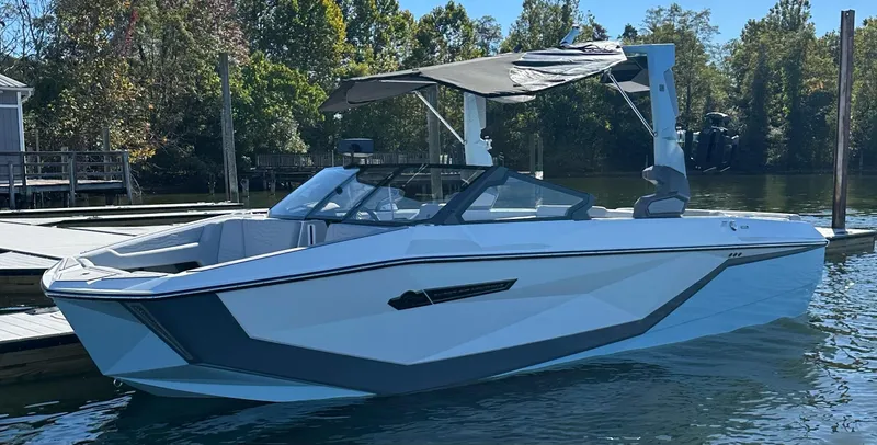 Slide: The Image of 2025 Nautique Super Air Nautique G23 boat docked on a sunny day. - 4
