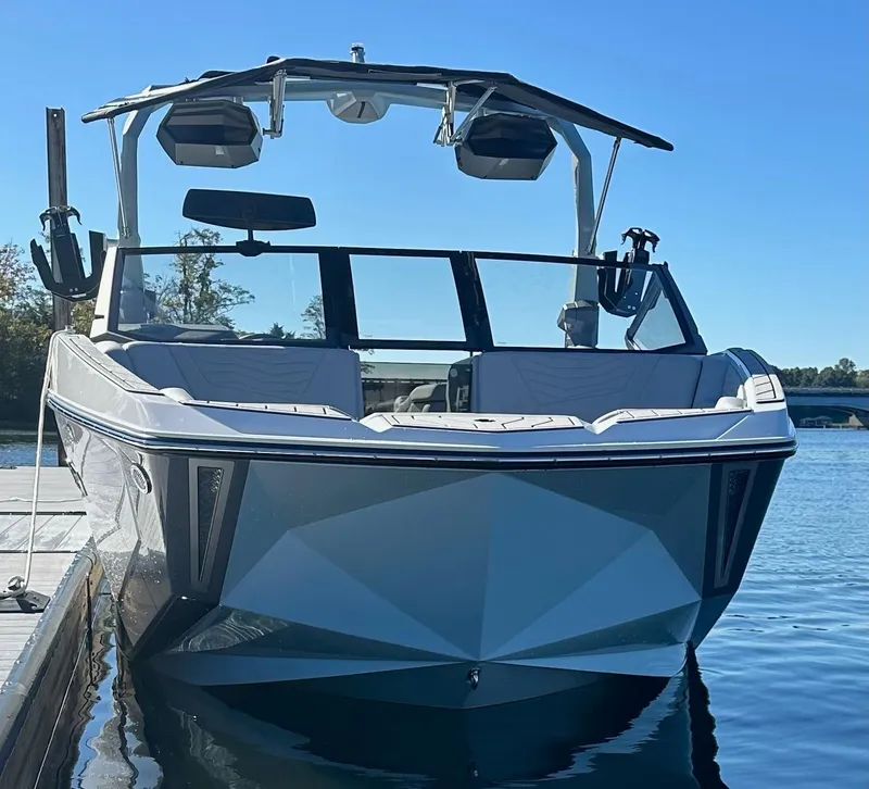 Slide: The Image of 2025 Nautique Super Air Nautique G23 boat docked on a sunny day. - 5