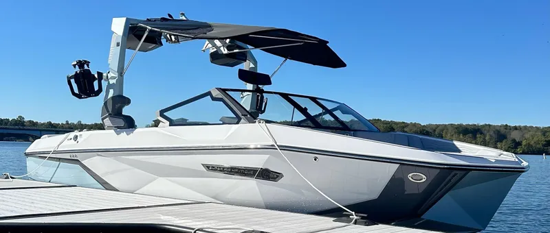 Slide: The Image of 2025 Nautique Super Air Nautique G23 boat docked on a sunny day. - 6
