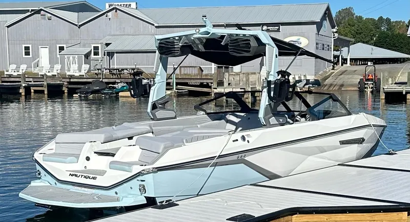 Slide: The Image of 2025 Nautique Super Air Nautique G23 boat docked at marina. - 7