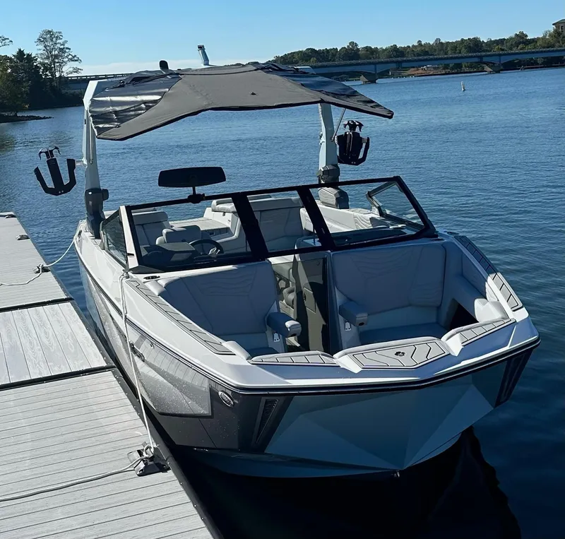 Slide: The Image of 2025 Nautique Super Air Nautique G23 boat docked on a sunny day. - 8