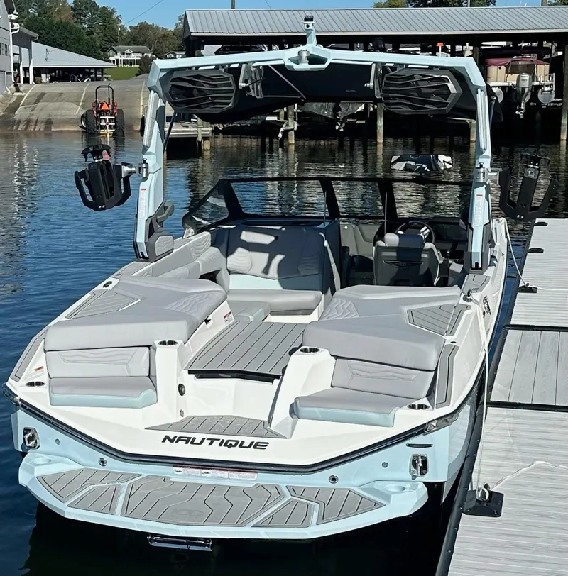 Slide: The Image of 2025 Nautique Super Air Nautique G23 boat docked, featuring sleek design and spacious seating. - 9