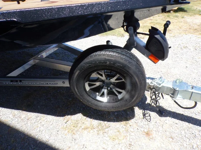 Slide: The Image of Trailer wheel of 2026 Xpress H20 Bass boat on gravel surface. - 15
