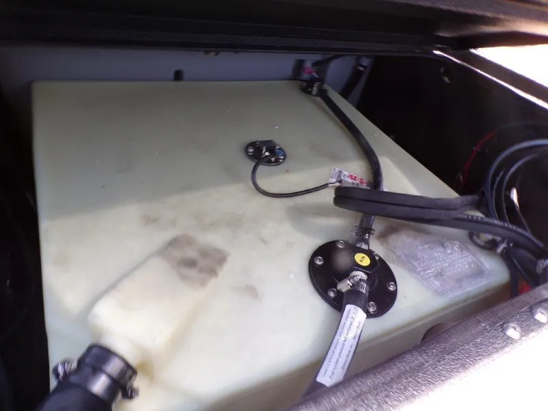 Slide: The Image of Fuel tank compartment of 2026 Xpress H20 Bass boat with connected hoses. - 18