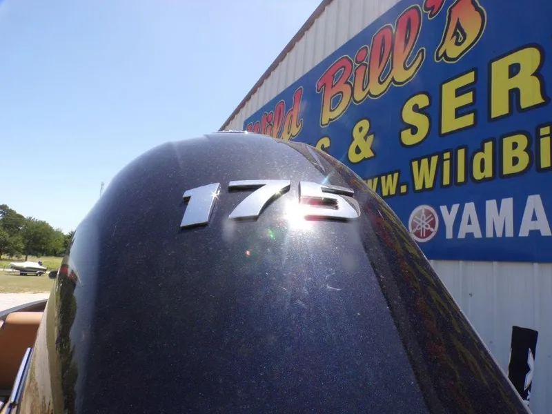 Slide: The Image of Outboard motor with "175" emblem, near Wild Bill's sign, Xpress H20 Bass 2026. - 2