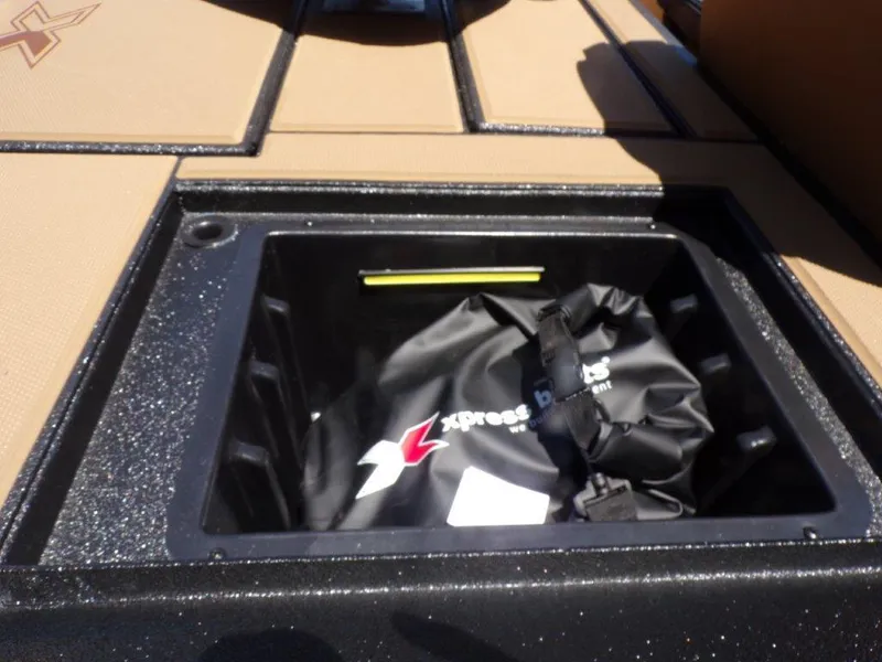 Slide: The Image of Storage compartment of 2026 Xpress H20 Bass boat with gear bag inside. - 21
