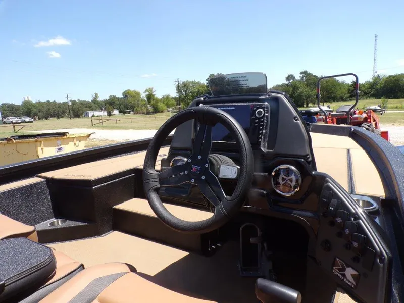 Slide: The Image of 2026 Xpress H20 Bass boat cockpit with steering wheel and control panel. - 22